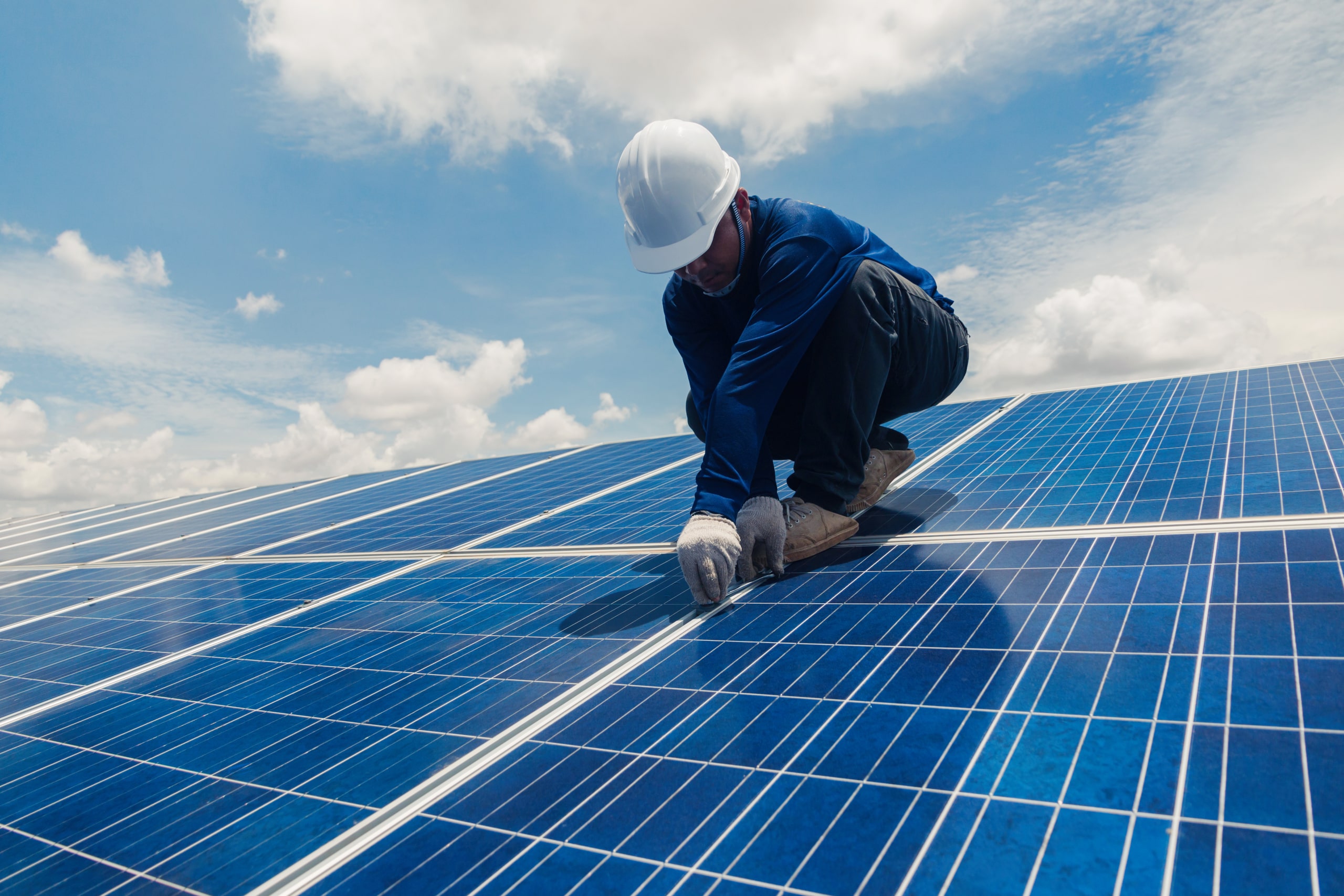 Photo of an electrician installing solar panels